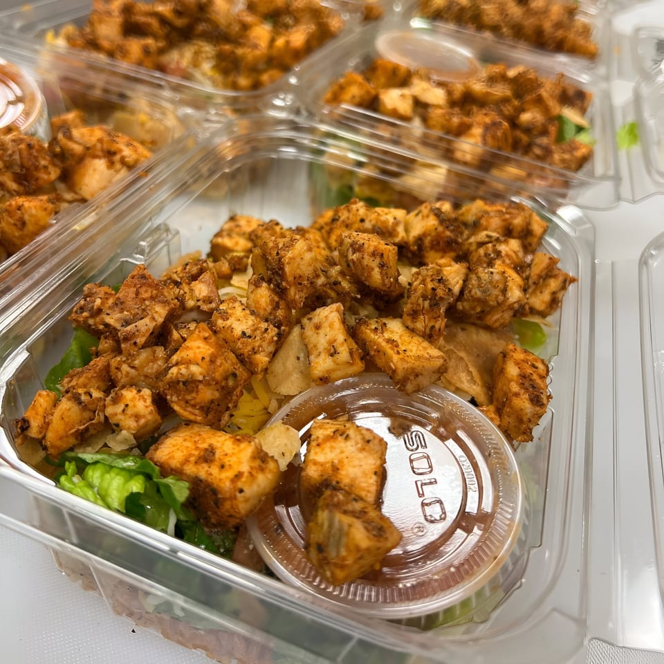 Multiple Litehouse Whole Food Grill healthy chicken and salad meals in clear plastic containers.
